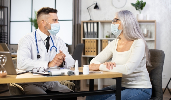 A masked patient having a check-up at a modern clinic