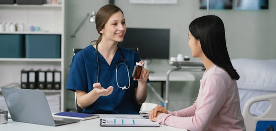A clinician with a tablet talking to a patient