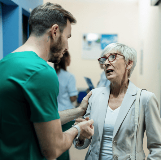 A clinician talking with a patient in a corridor